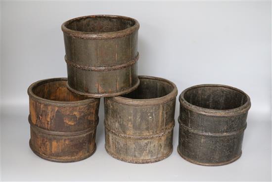 A set of four iron mounted wooden pots